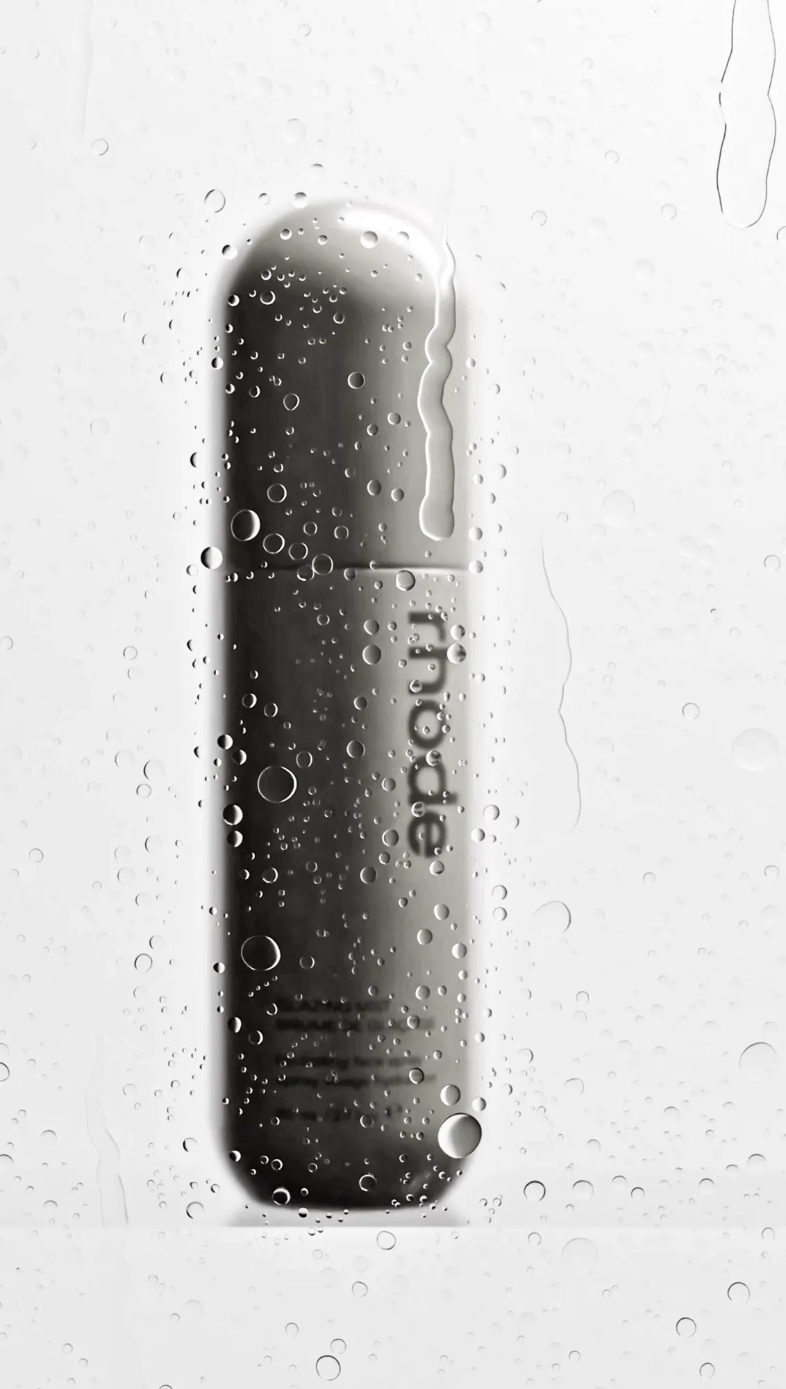 Matte skincare bottle covered in water drops